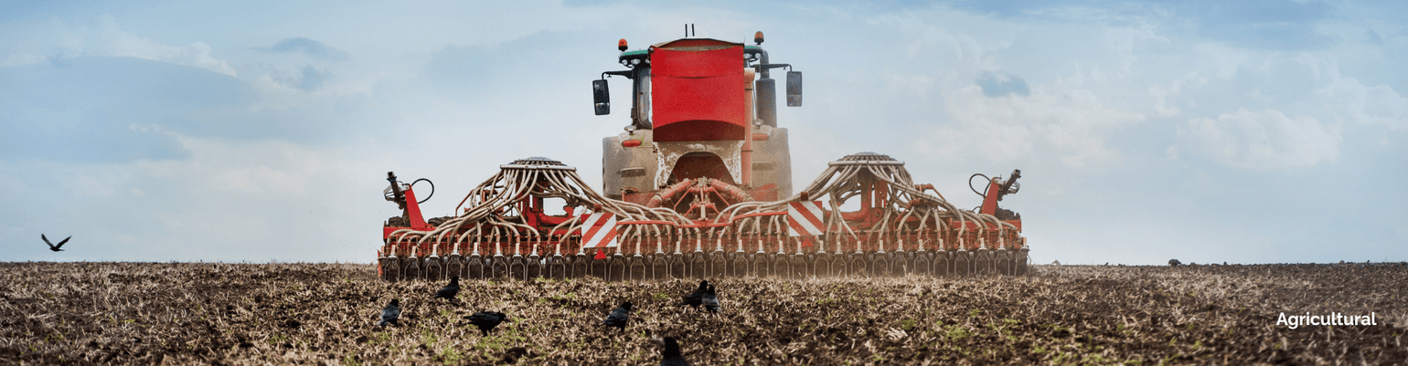 Tractor preparing agricultural land with advanced equipment for effective crop planting and soil management.