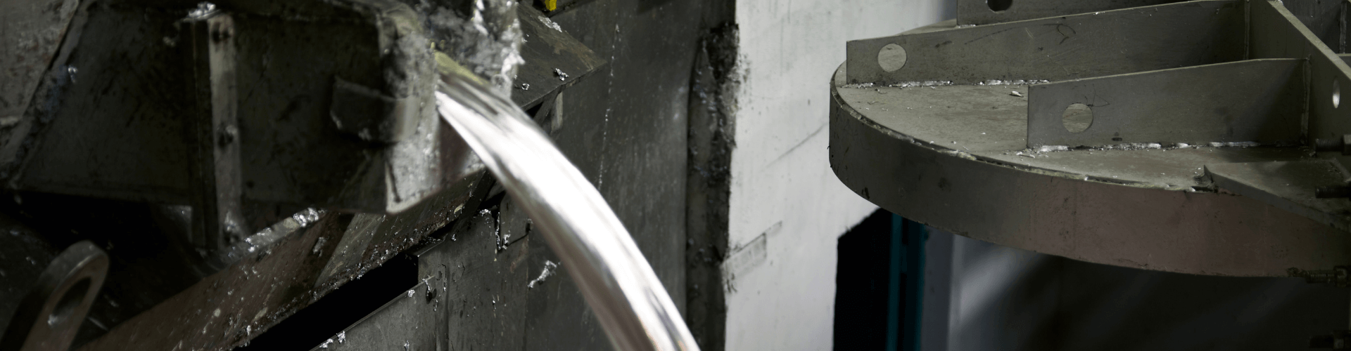 Interior view of aluminum processing equipment handling molten metal, showcasing heat and abrasion-resistant features.