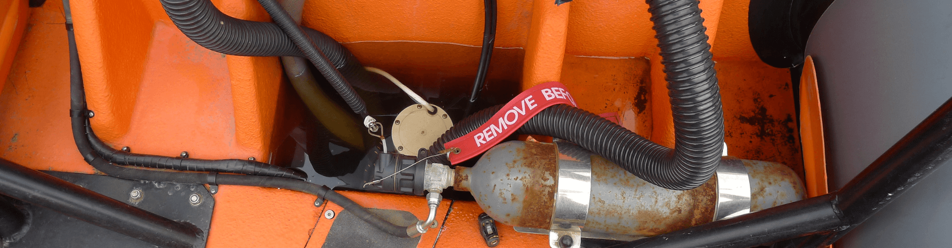 Marine bilge system with hoses for strong suction, showing components resistant to saltwater and waste fluids.