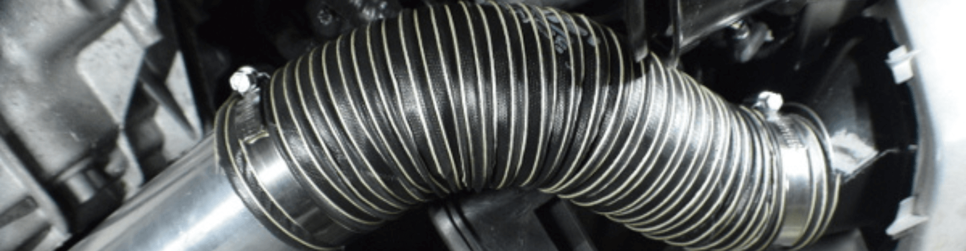 Close-up of lightweight brake ducting providing airflow to enhance heat dissipation in performance racing systems.