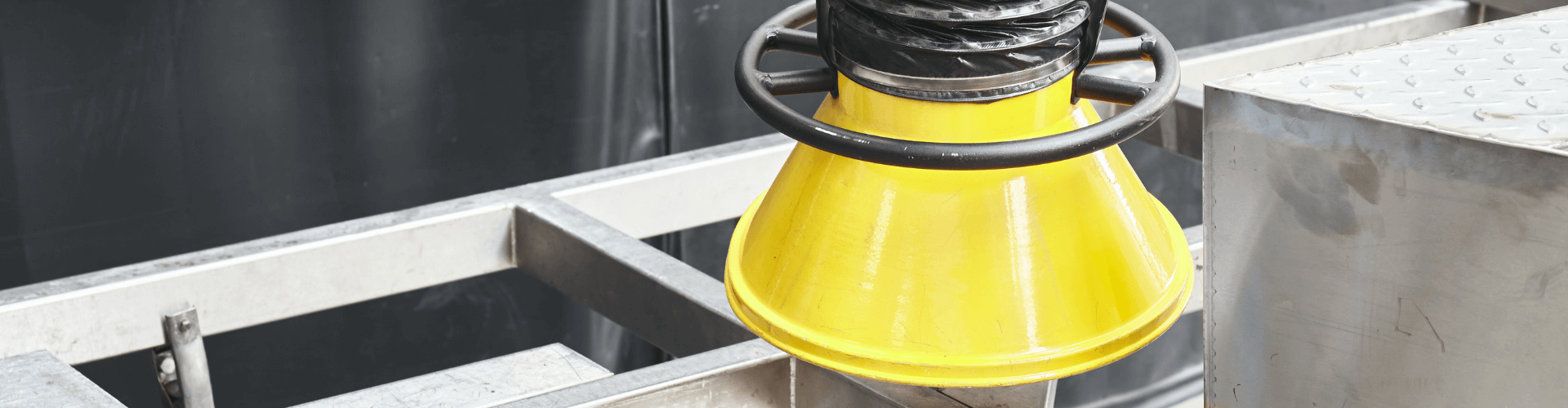 Yellow chemical fume extraction hood designed for safe containment of hazardous air in industrial settings.