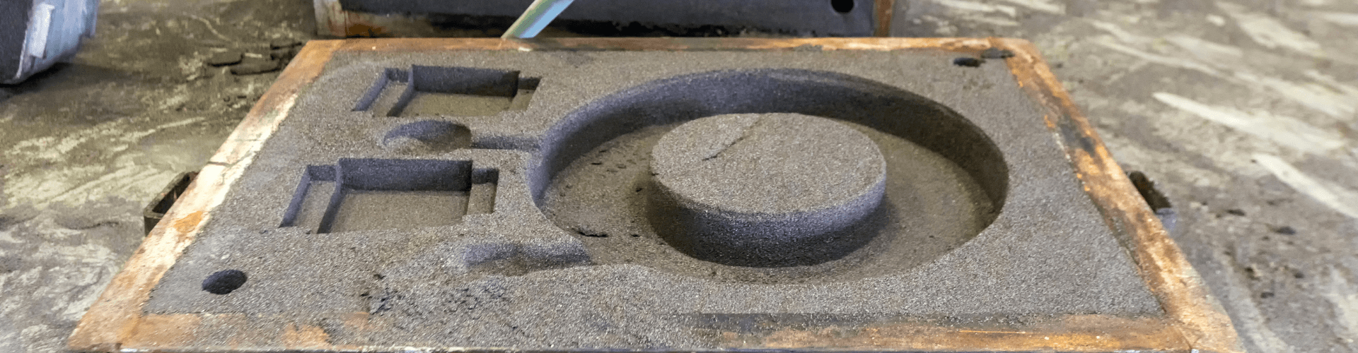 Foundry sand transfer mold showcasing abrasive sand pattern for high-durability applications.