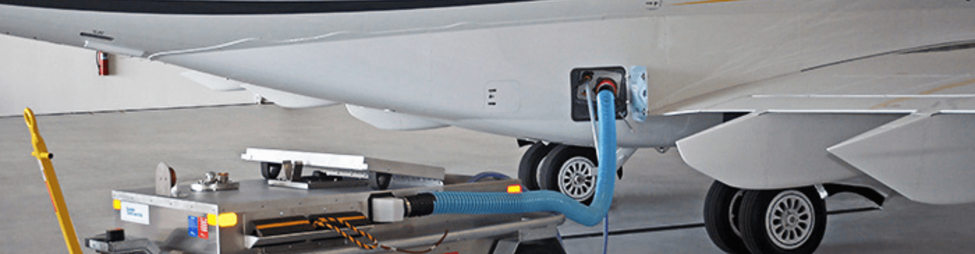 Aircraft lavatory waste disposal system featuring flexible, chemical-resistant hoses for secure waste handling.