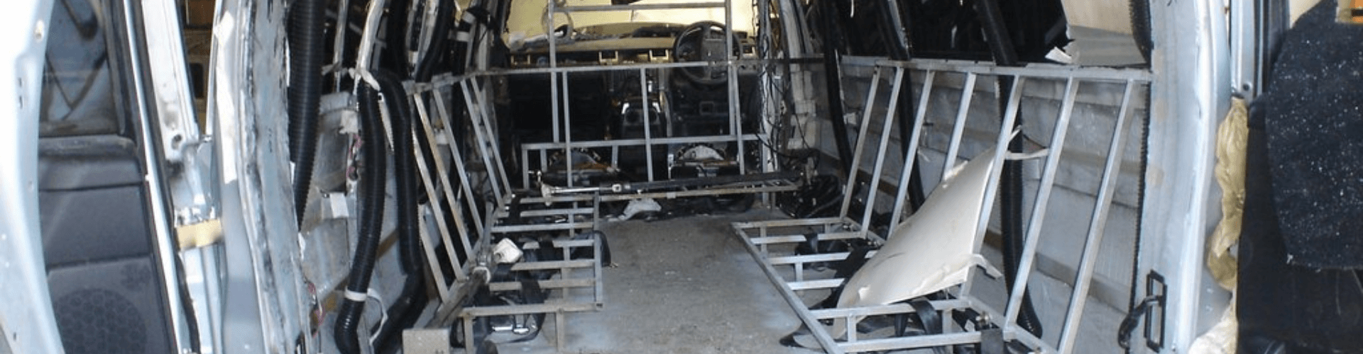 Interior view of a limousine showing framework and structural components for A/C duct installation.