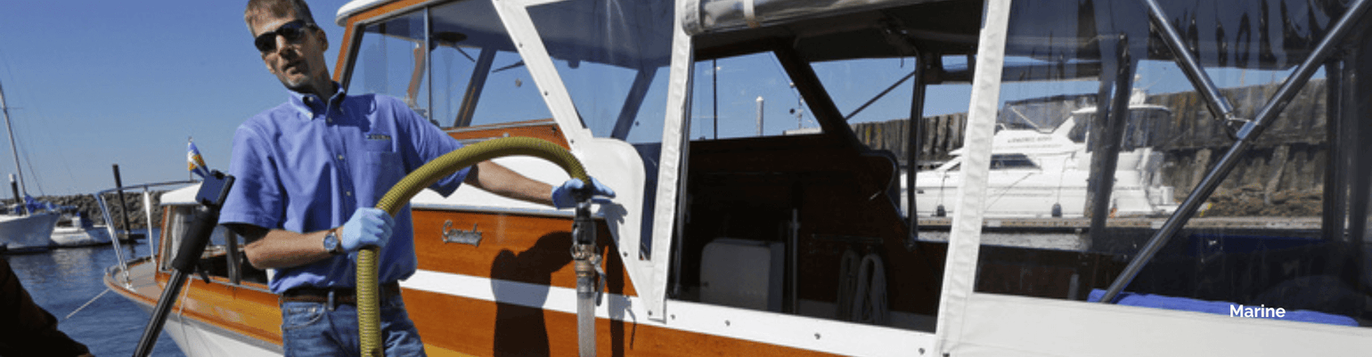 Man operating bilge pump on a boat, ensuring sanitation and ventilation for marine applications.
