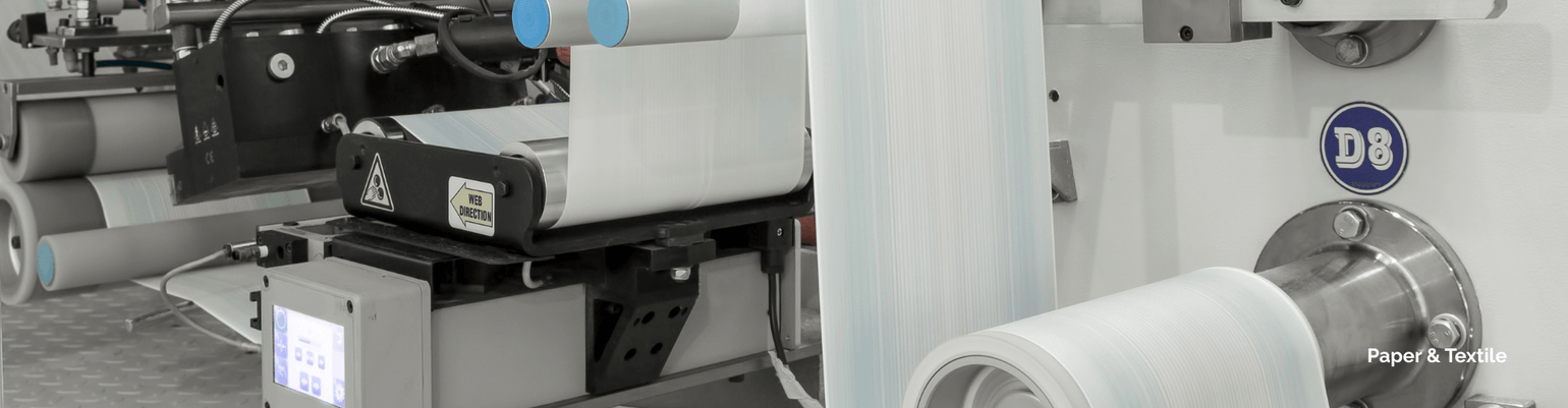 Close-up of paper and textile application machinery for dust collection and fiber capture.