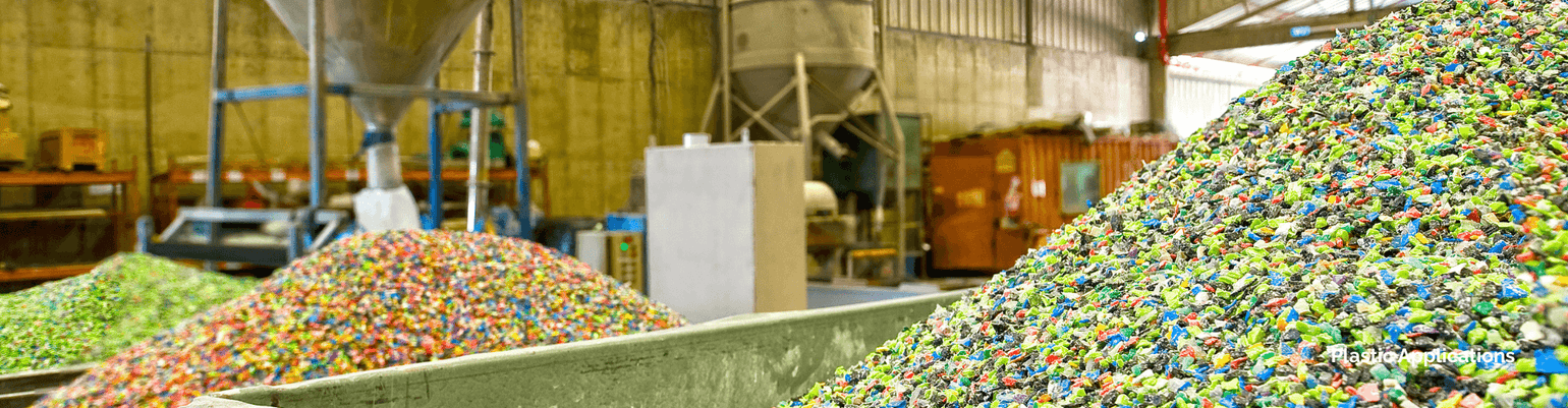 Colorful plastic pellets in a manufacturing facility, highlighting plastic applications in production processes.