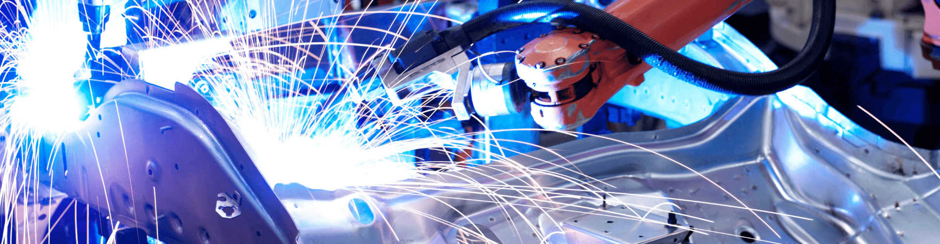 Robotic welding process with sparks, showcasing advanced manufacturing techniques in RV production.