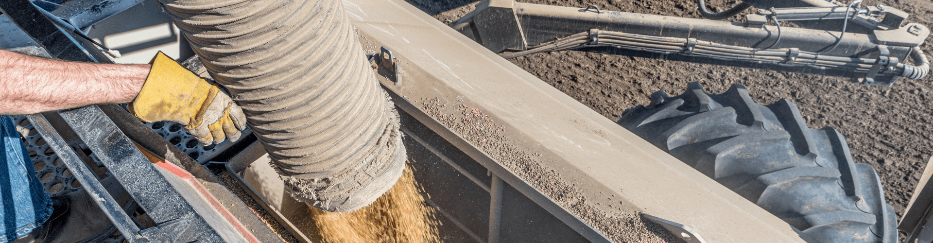 Railcar loading operation showing dry bulk material transfer with abrasion-resistant equipment and efficient flow.