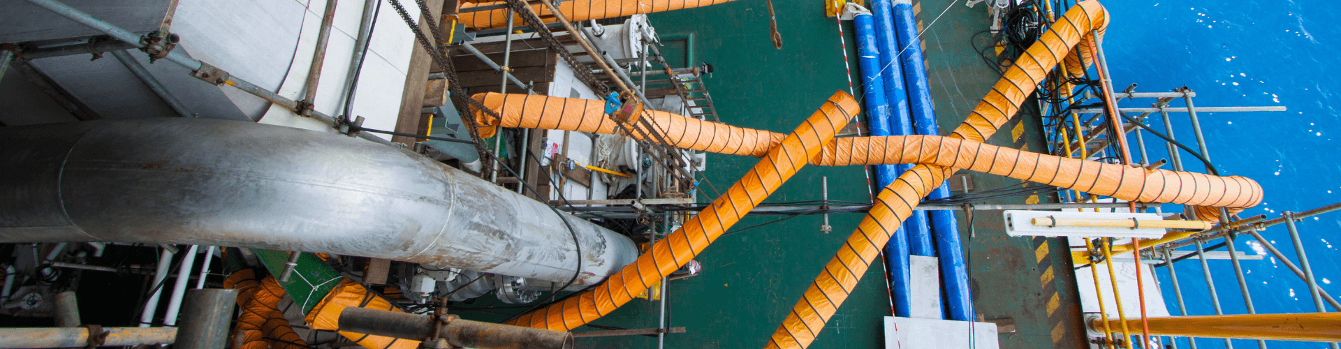Shipyard ventilation system with fume extraction and debris removal hoses in a wet, abrasive environment.