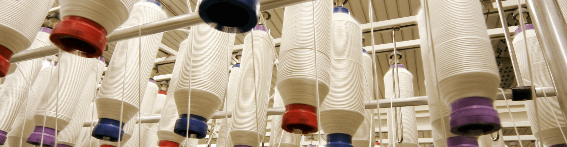 Textile Fiber Collection featuring spools of light fibers, ideal for lint control and static performance in textile processing.