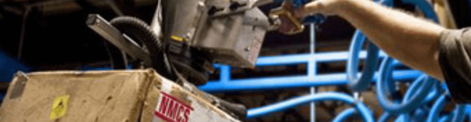 Operator using a vacuum lifting system to handle material safely and efficiently.