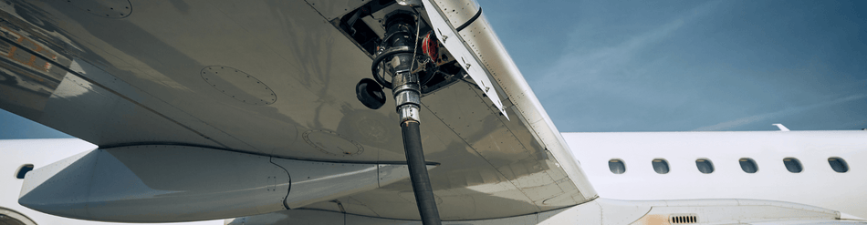 Jet fuel venting hose connected to an aircraft wing, showcasing safe handling of volatile vapors in aviation.