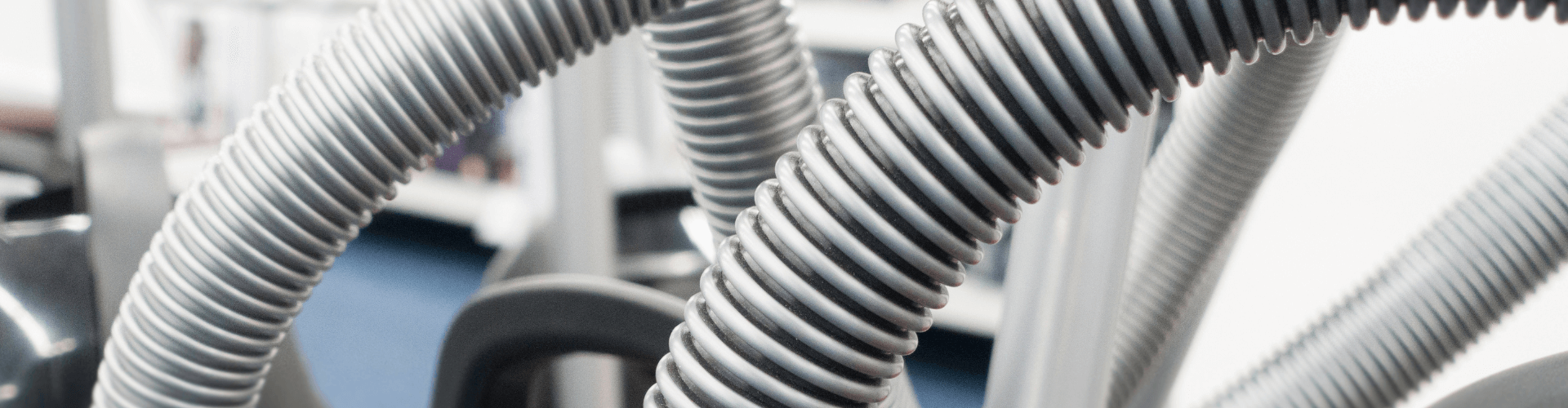 Close-up of durable, flexible vacuum hoses designed for effective dry debris collection in workshops.