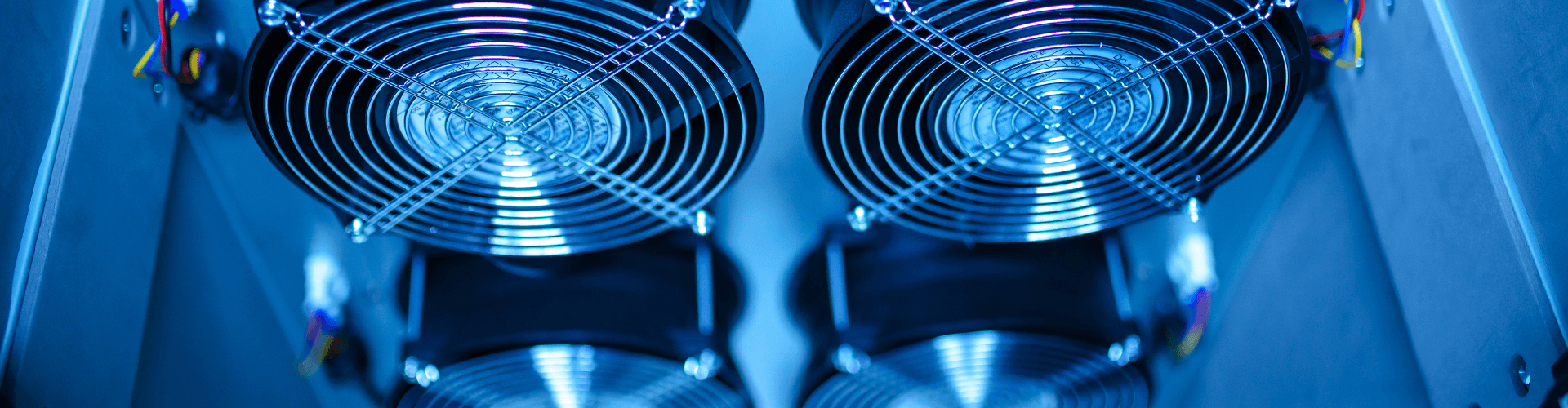 Close-up of dual electronic cooling fans inside a panel, designed for efficient airflow management in electronic enclosures.