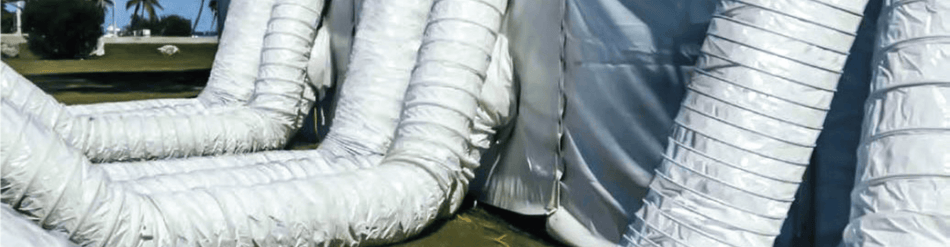 White HVAC hoses connected to a portable event tent for efficient heating and cooling management.