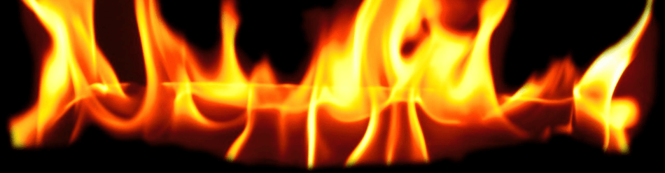 Close-up of vibrant flames against a black background, illustrating fire hazards and risks.