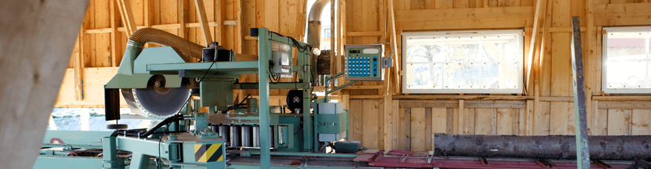 Lumber mill machinery designed for efficient dust and chip extraction during cutting and planing operations.