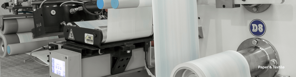 Close-up of paper and textile application machinery for dust collection and fiber capture.