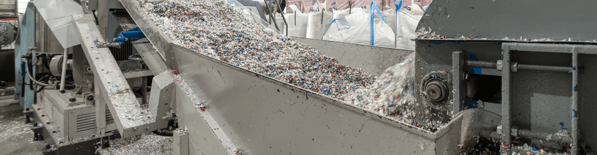 Industrial shredder conveying shredded materials like paper and plastic, showcasing strong airflow and clog resistance.