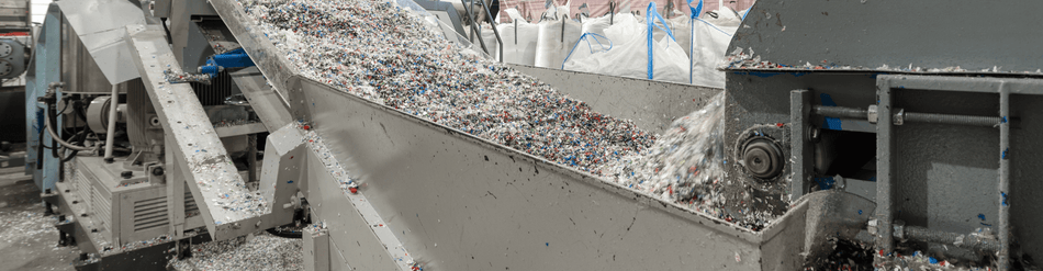 Industrial shredder conveying shredded materials like paper and plastic, showcasing strong airflow and clog resistance.