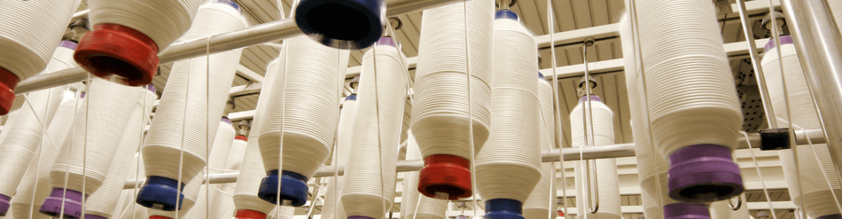 Textile Fiber Collection featuring spools of light fibers, ideal for lint control and static performance in textile processing.