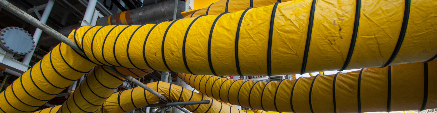 Yellow ducts with black stripes on a metal framework