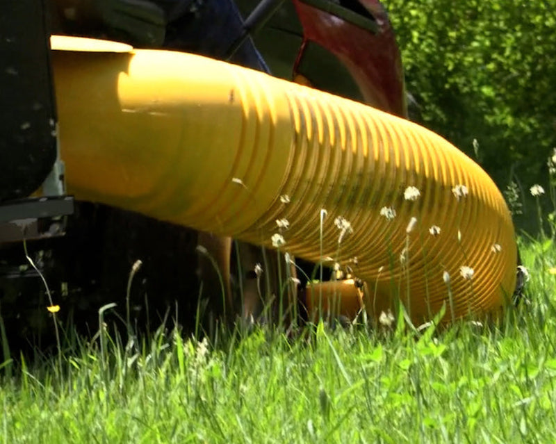 Close-up of a yellow industrial hose on grass