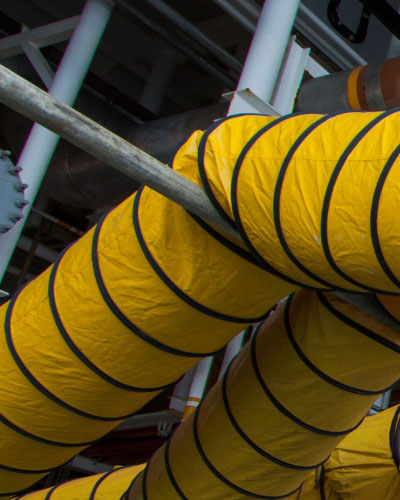 Yellow duct with black stripes on a metal frame