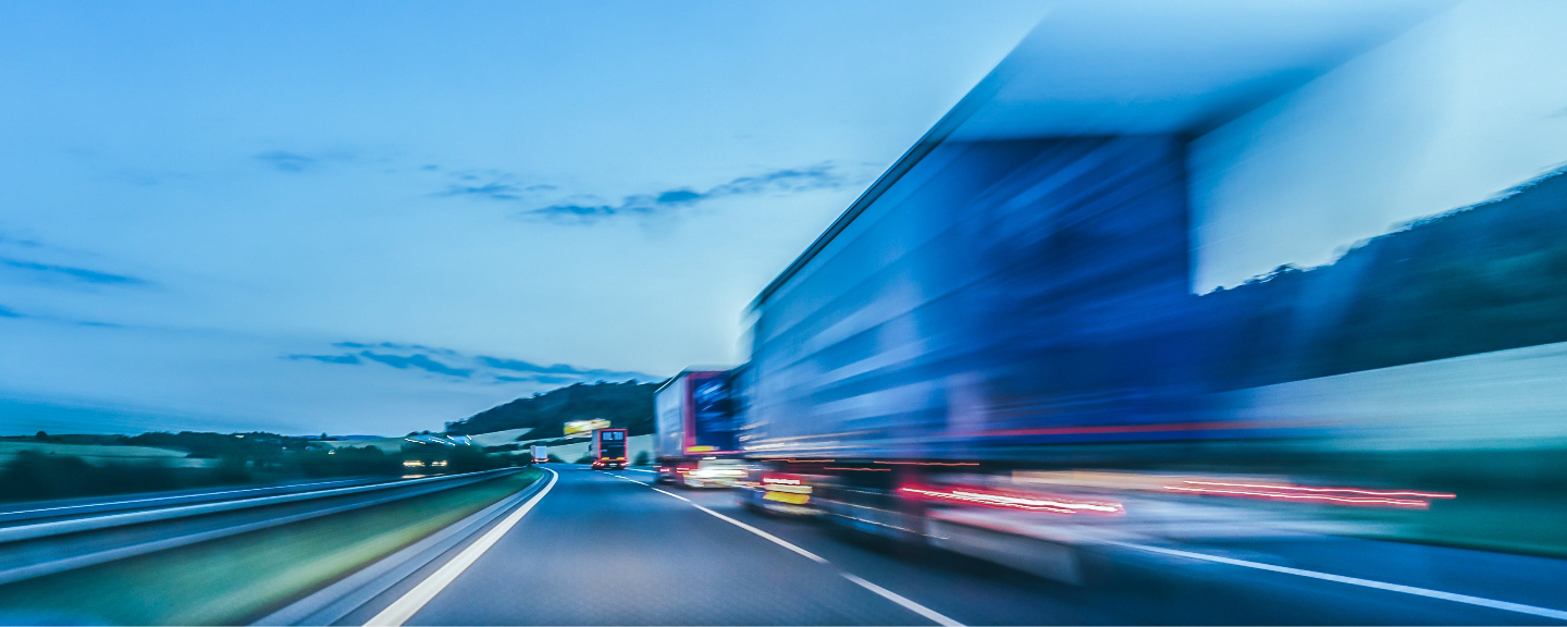 Truck driving on a highway at night with motion blur