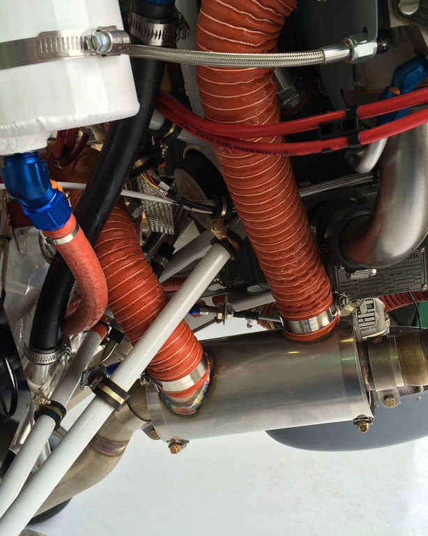 Close-up of mechanical components with orange and black hoses on a white background